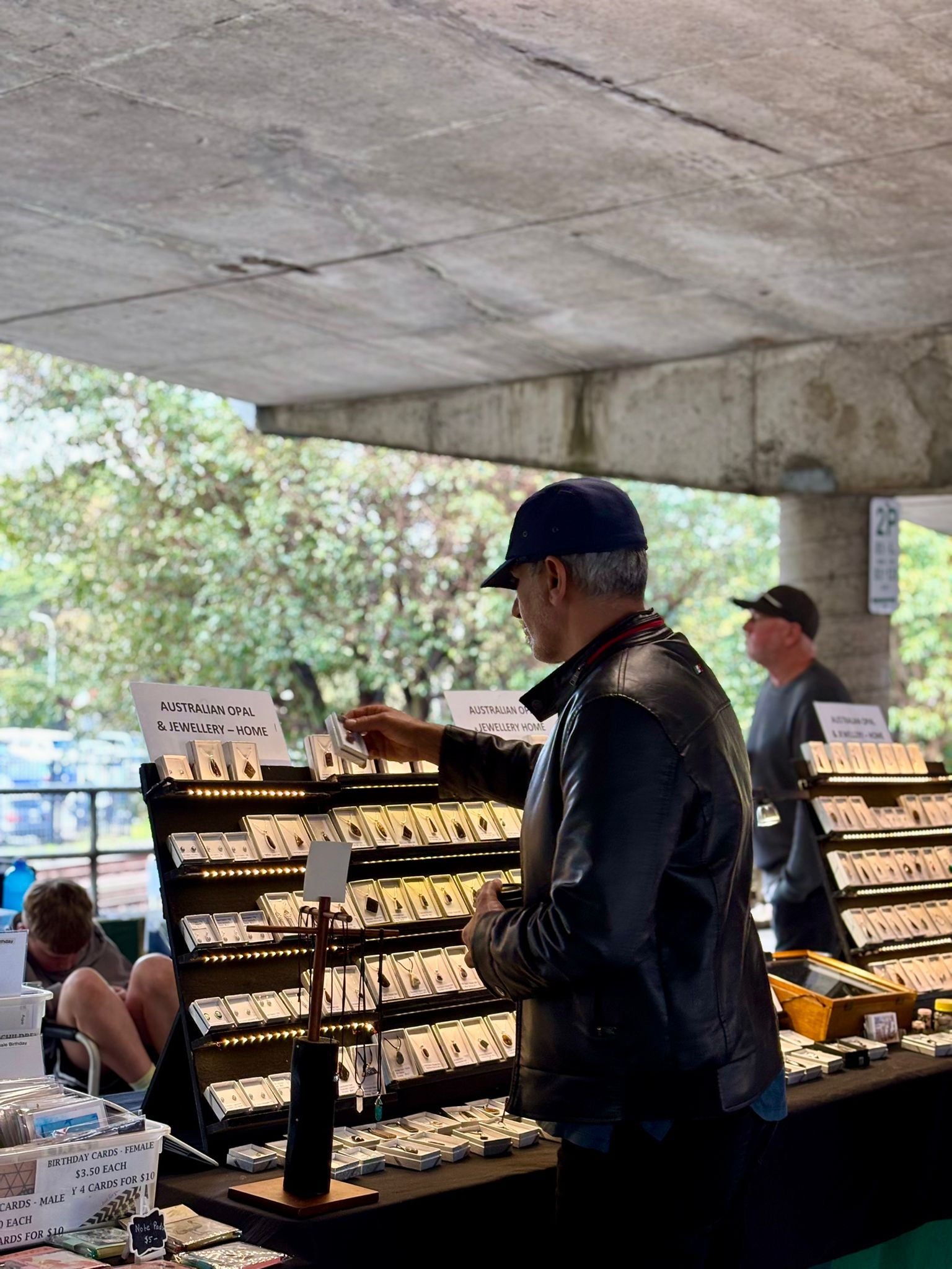 Man looking at Australian-made jewellery.