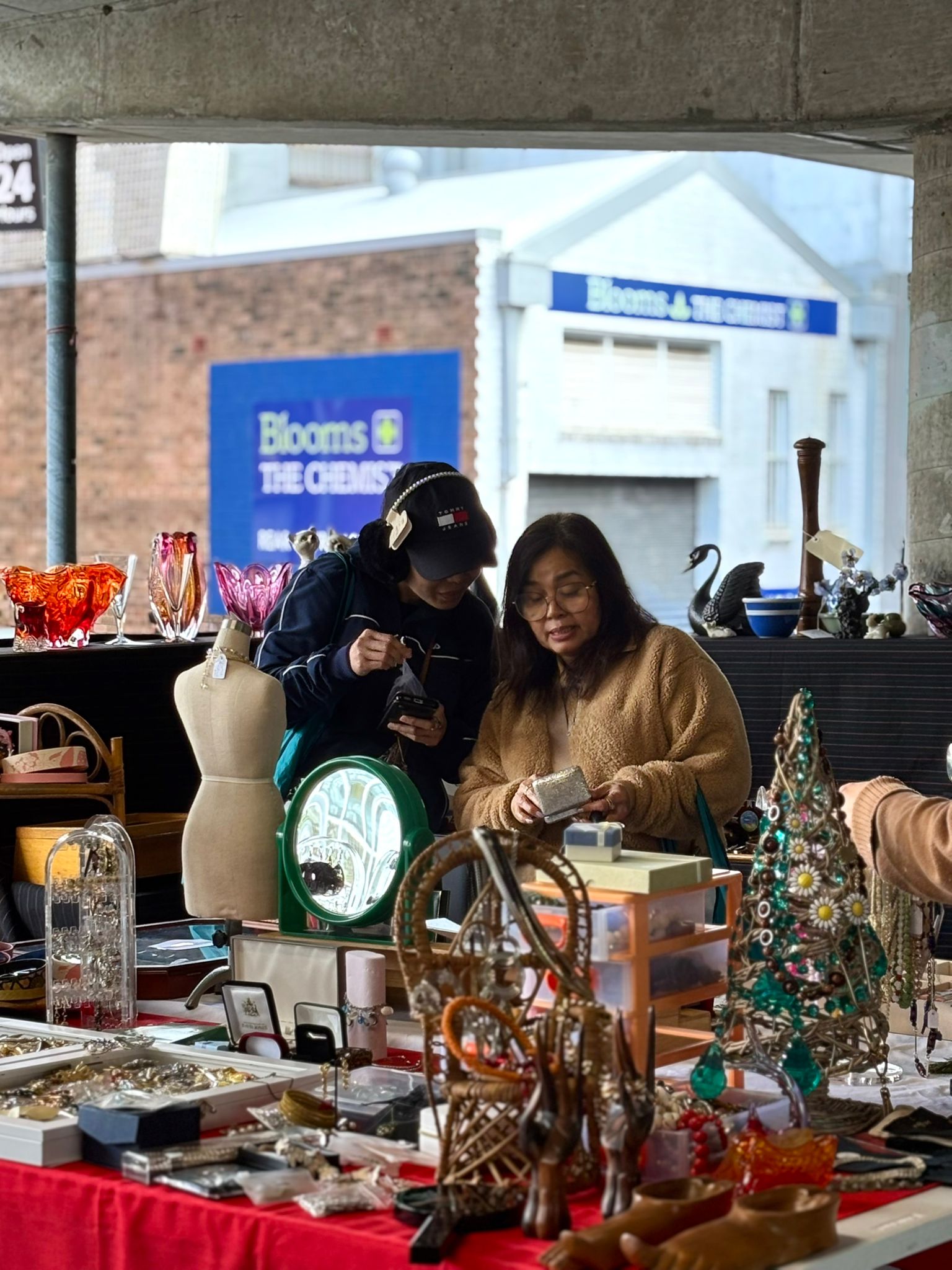 Two women at the Gordon Markets interacting.