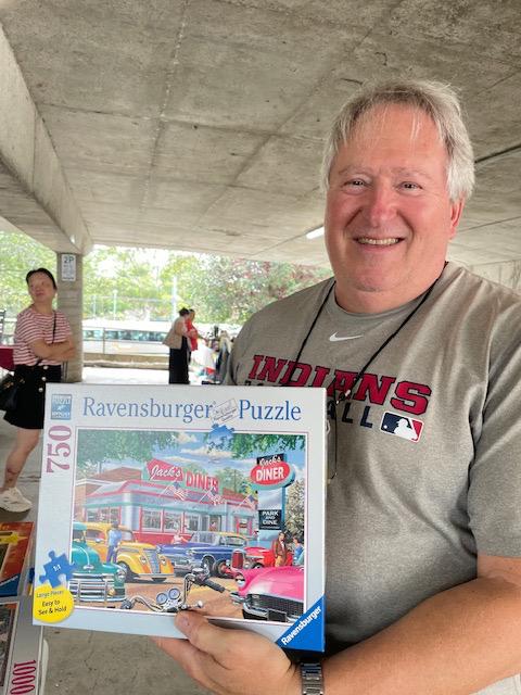 Image of man (Jeff) holding a Ravensburger puzzle