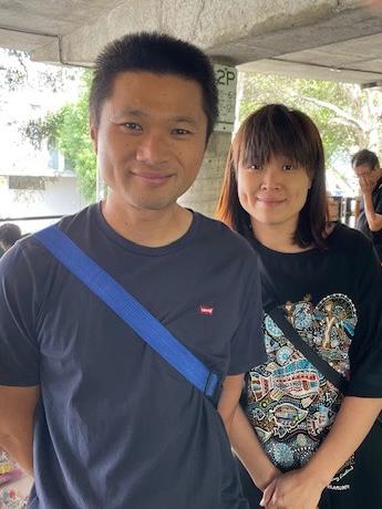 Image of man and woman (Jeremy and Nicole) standing in front of their stall.